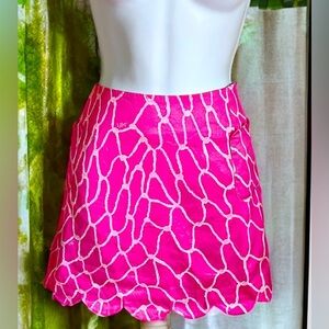 Lilly Pulitzer pink mini skirt with linens shorts underneath